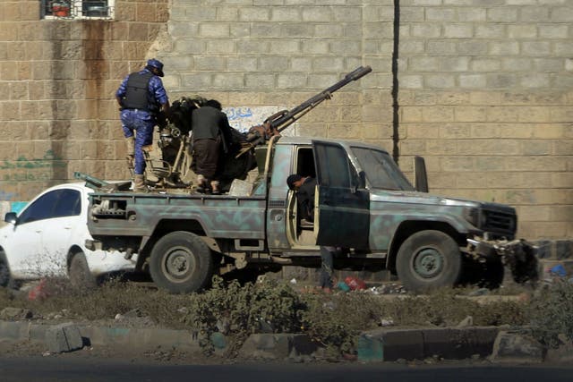Houthi fighters man an anti-aircraft gun in the Yemeni capital Sanaa amid clashes with supporters of Yemeni ex-president Ali Abdullah Saleh