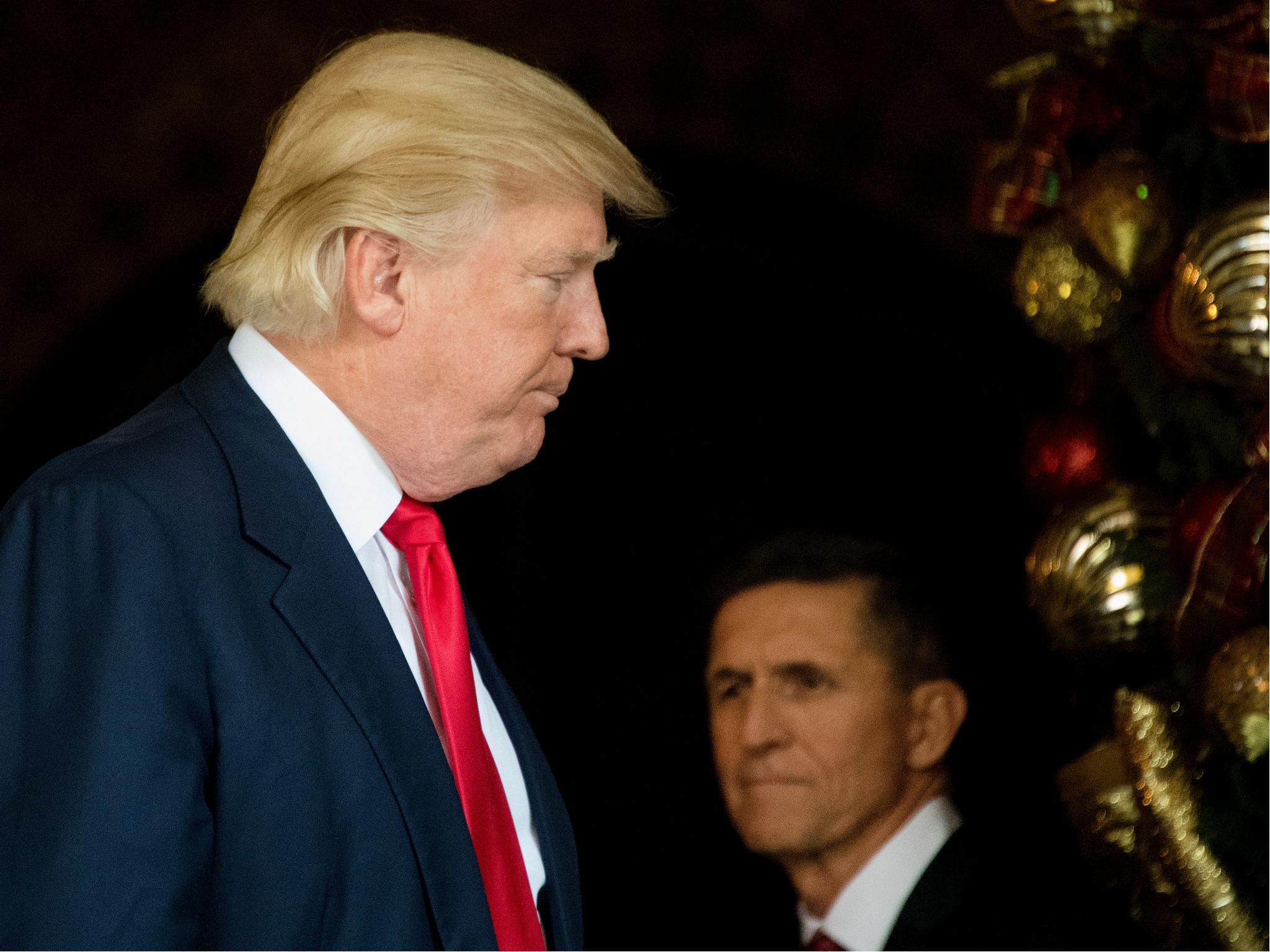 US Presiden Donald Trump stands with former National Security Adviser Michael Flynn at Mar-a-Lago in Palm Beach, Florida on 21 December 2016.