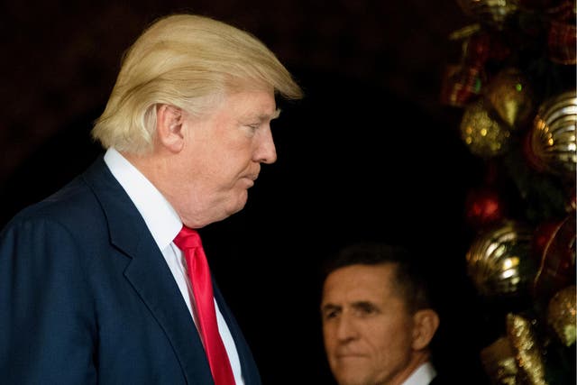 US Presiden Donald Trump stands with former National Security Adviser Michael Flynn at Mar-a-Lago in Palm Beach, Florida on 21 December 2016.