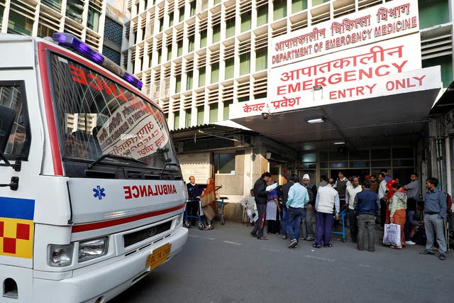 <p>Representational purposes only. An ambulance arrives as people stand at the entrance of the emergency department of a government-run hospital in New Delhi</p>