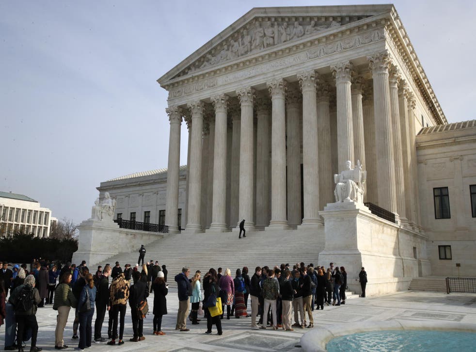The United States Supreme Court with a line of people waiting outside its front steps