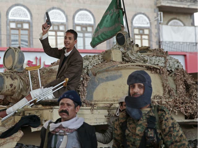 Houthi fighters guard a street leading to the residence of former Yemeni President Ali Abdullah Saleh