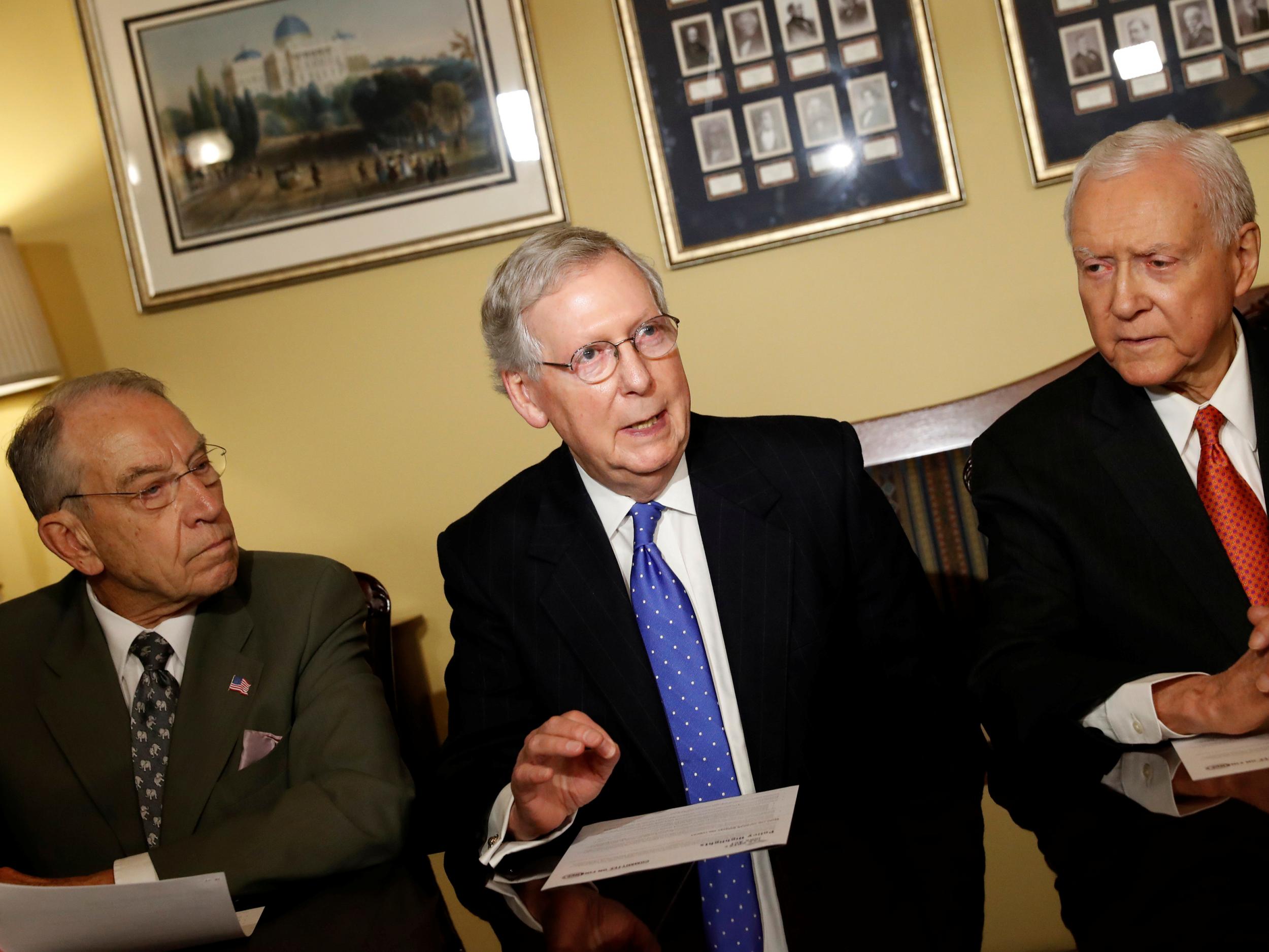 Senators Chuck Grassley (left) and Orrin Hatch (right) with Senate Majority Leader Mitch McConnell introducing the Republican tax reform plan at the US Capitol in Washington