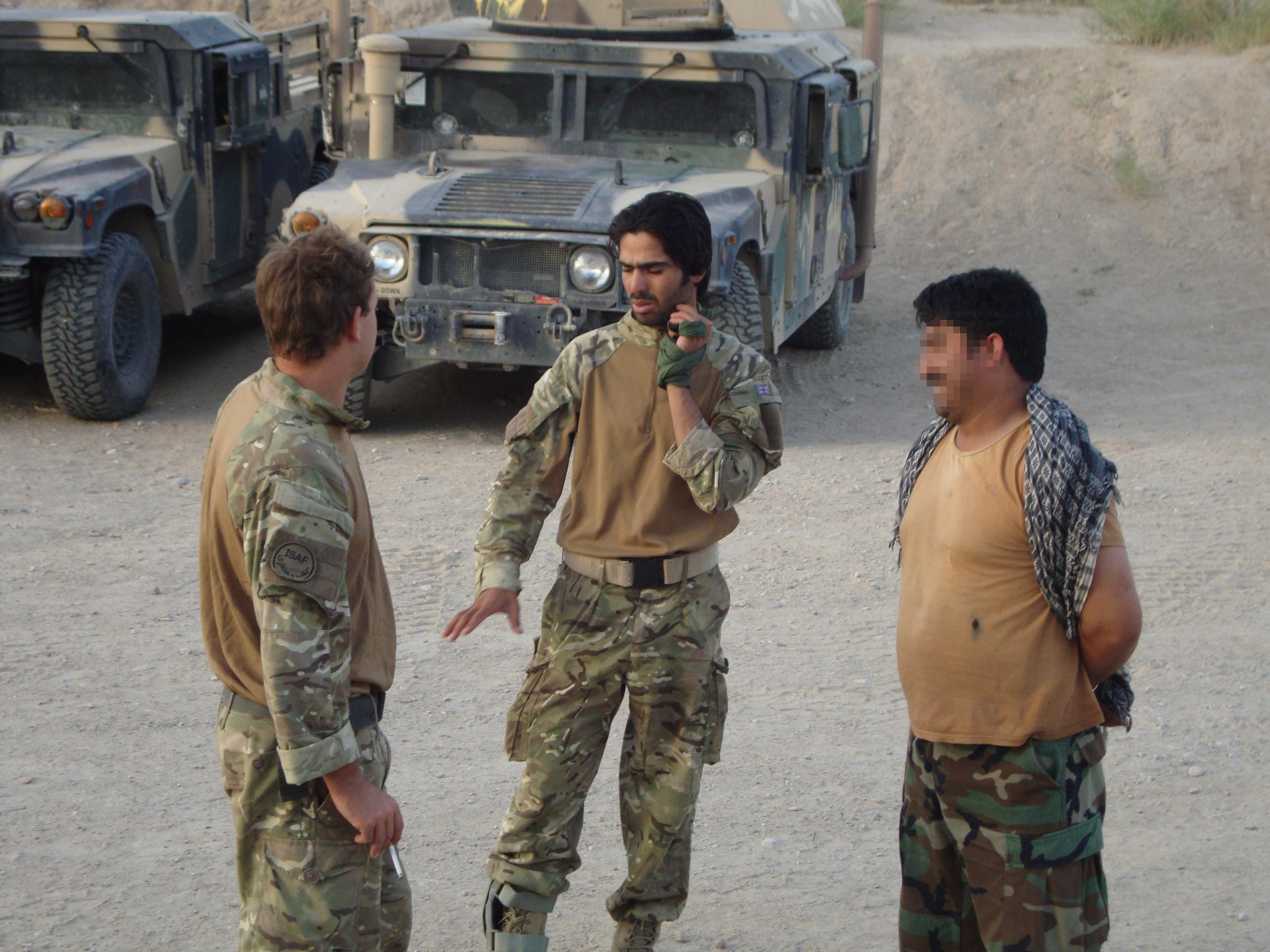 Mr Husseinkhel (centre) worked as an interpreter for a British Army squadron in Helmand led by Mr Locke (left) in Afghanistan in 2011. He has now, after nearly two years in the UK, been told he is to be removed from the country within days