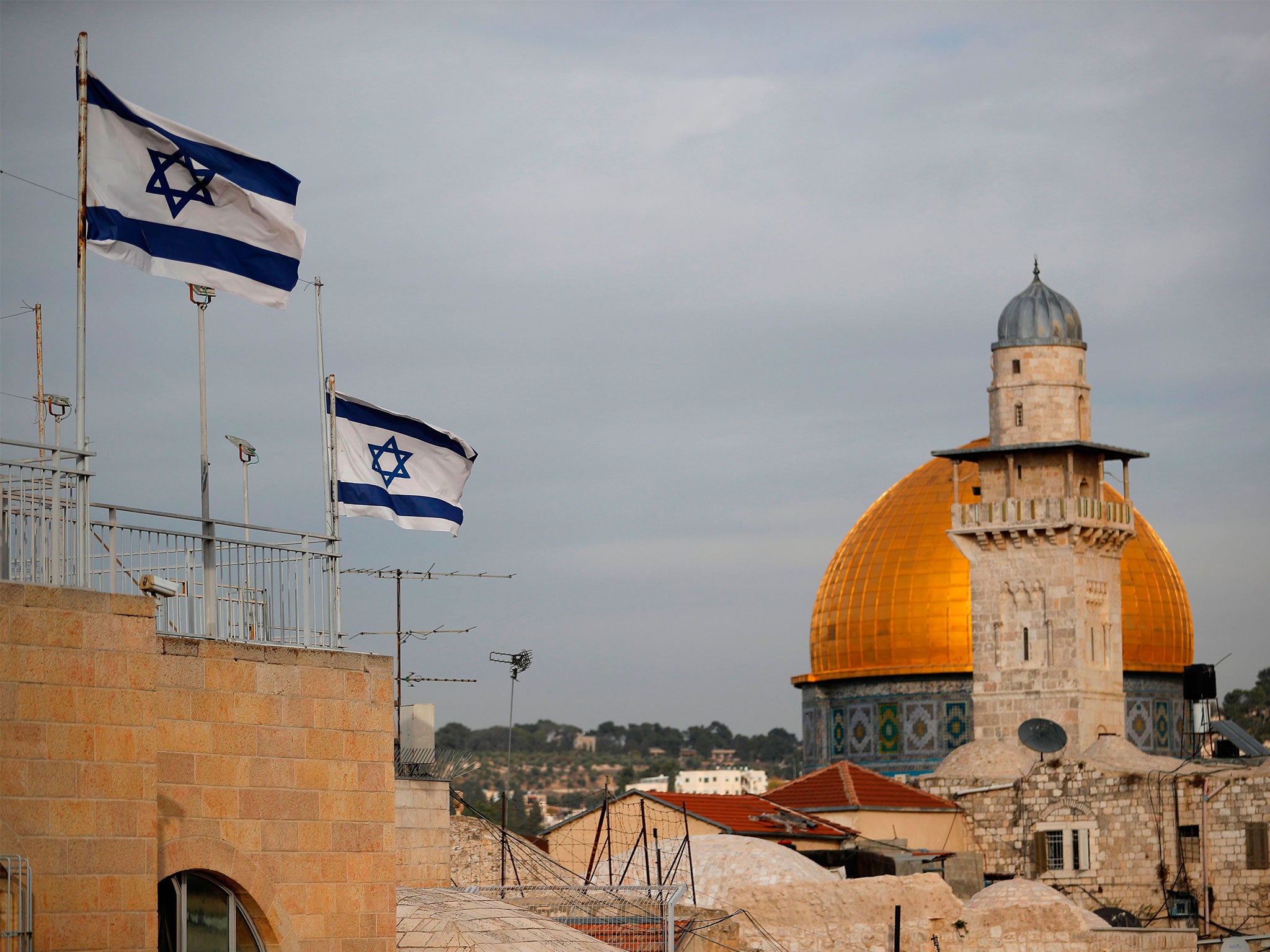 Israeli flags fly near the Dome of the Rock in the Al-Aqsa mosque compound, a holy site for both Jews and Muslims