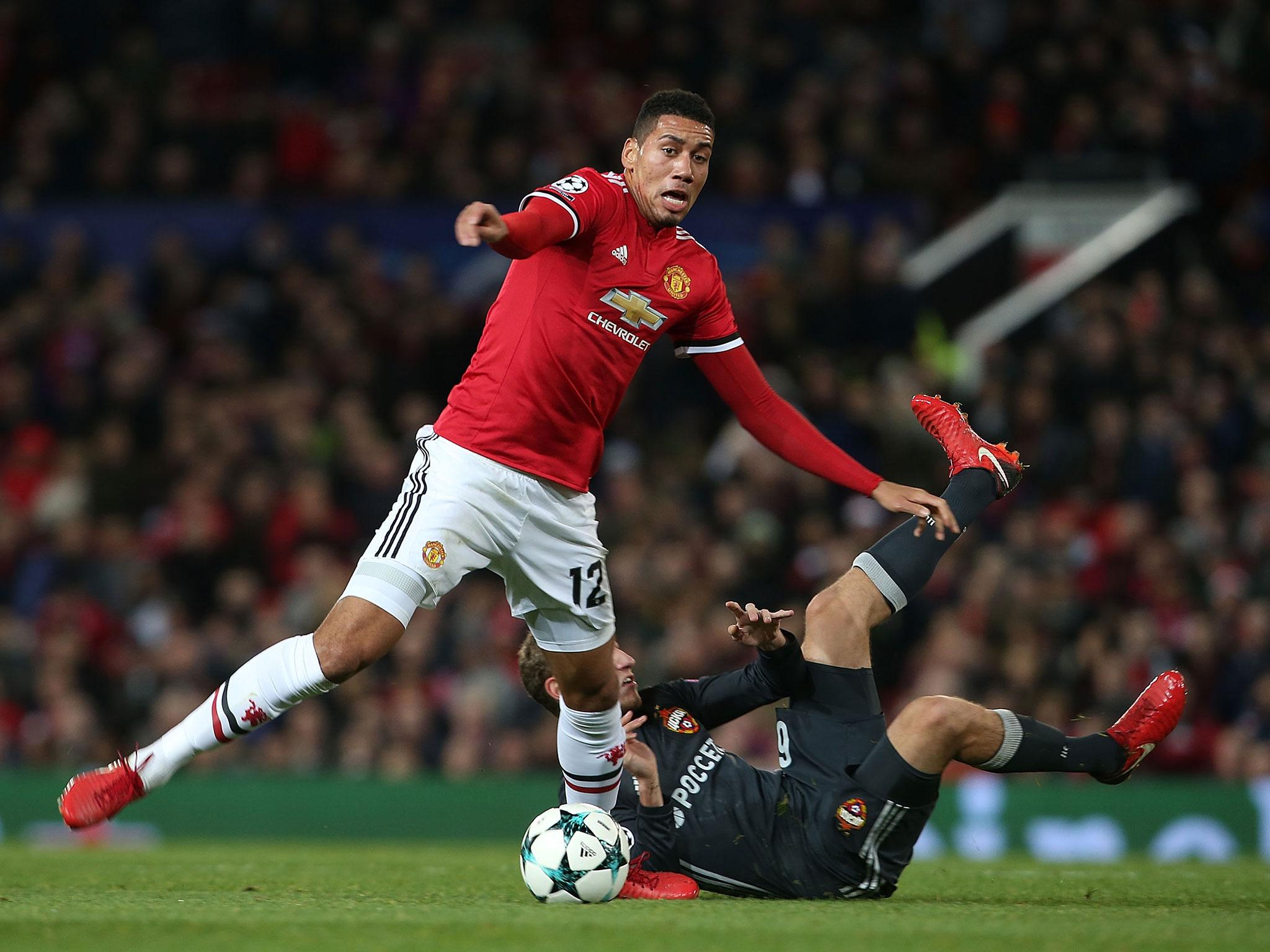 Chris Smalling brushes off a tackle to maintain possession (Getty)
