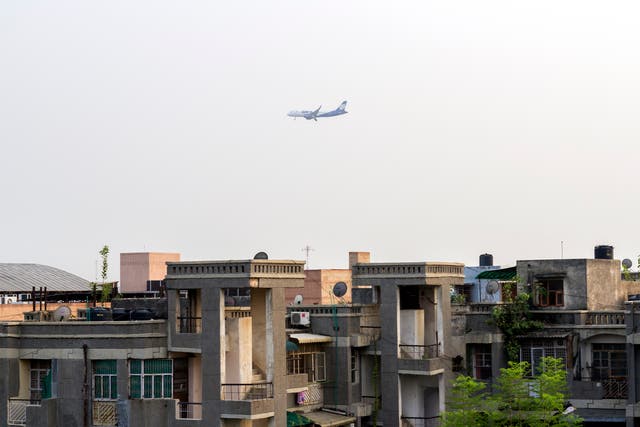 File: An aircraft belonging to GoAir Airlines flies over a residential area in south-west Delhi
