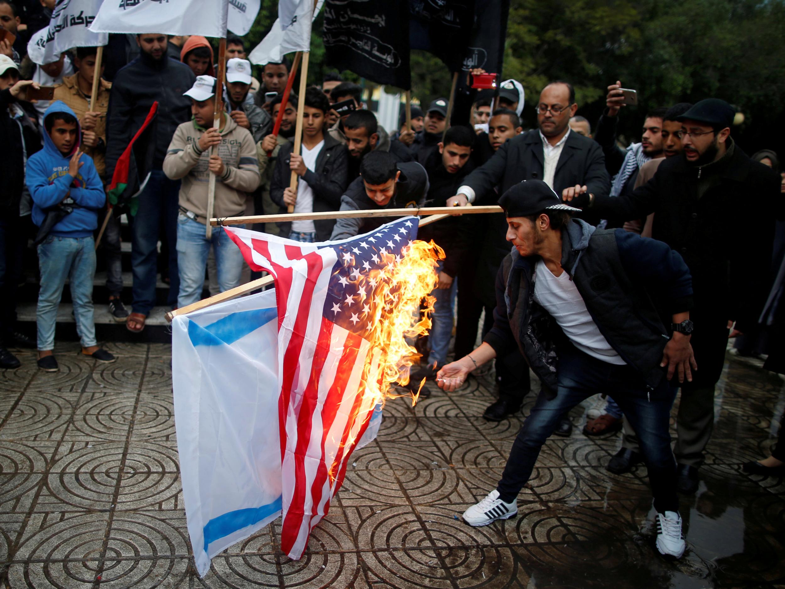 Palestinians burn Israeli and American flags during a protest against Donald Trump’s intention to move the US embassy to Jerusalem