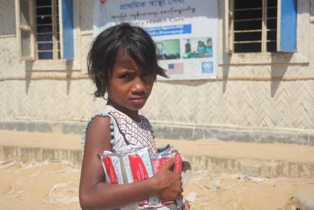 A Rohingya girl with supplies of therapeutic food at the Balukhali refugee camp