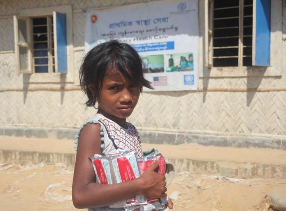 A Rohingya girl with supplies of therapeutic food at the Balukhali refugee camp