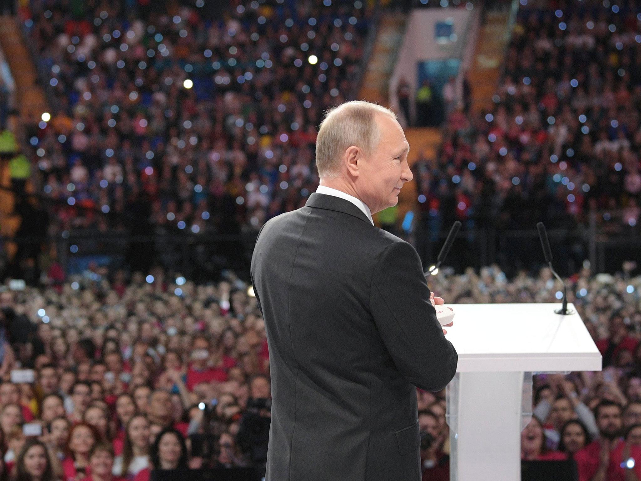 Russian President Vladimir Putin attends the forum of Russian volunteers at the Megasport Sport Palace in Moscow