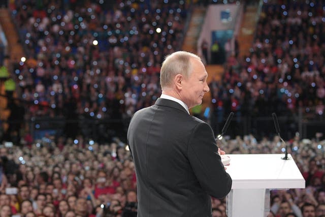 Russian President Vladimir Putin attends  the forum of Russian volunteers at the Megasport Sport Palace in Moscow