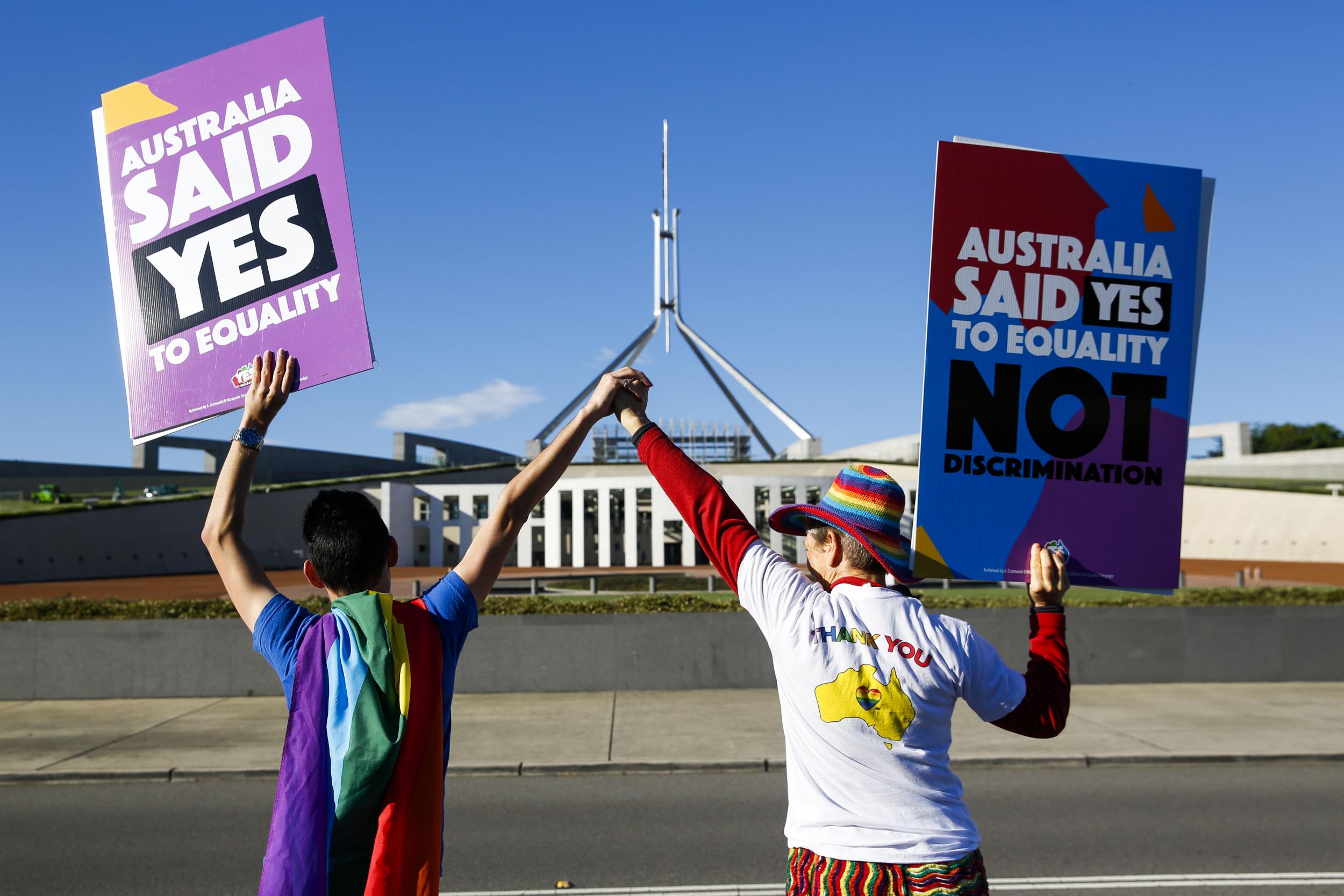 Campaigners in front of Australia's Parliament House in Canberra ahead of the vote on same-sex marriage