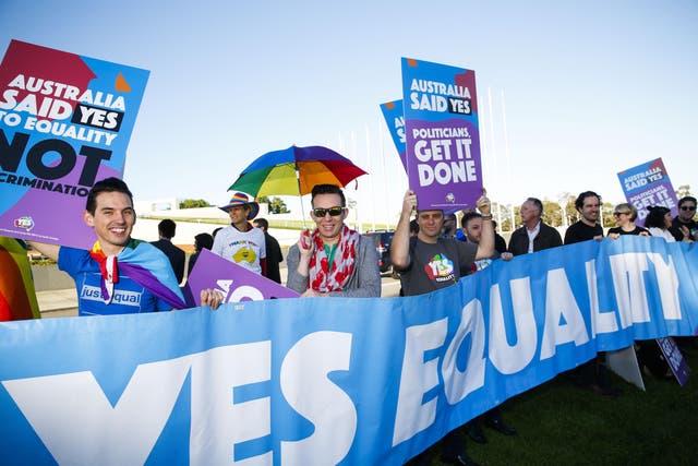 Equality campaigners gather in front of Parliament ahead of the same-sex marriage vote