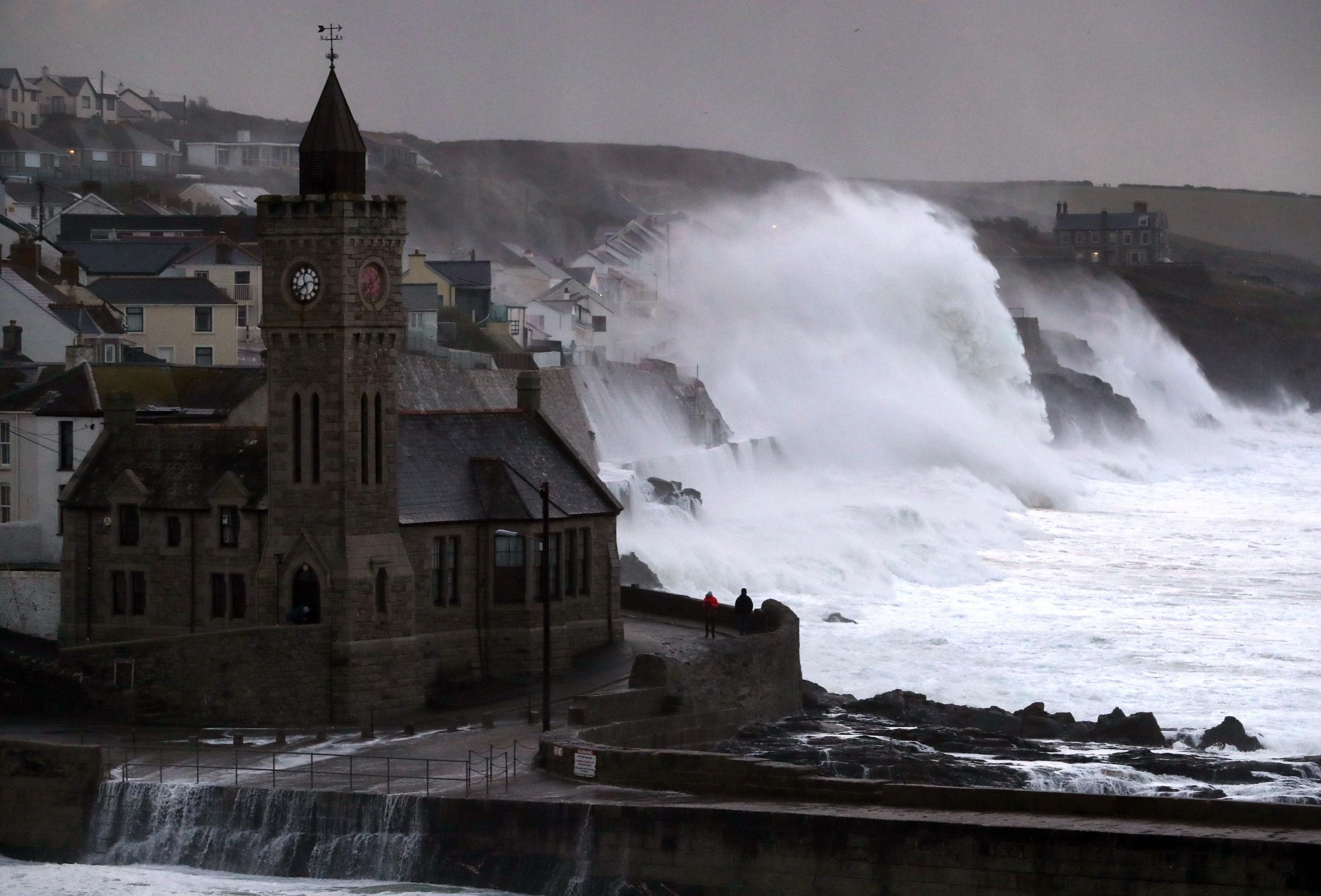 Waves crash into the seafront in Porthleven, Cornwall during 70mph winds in October