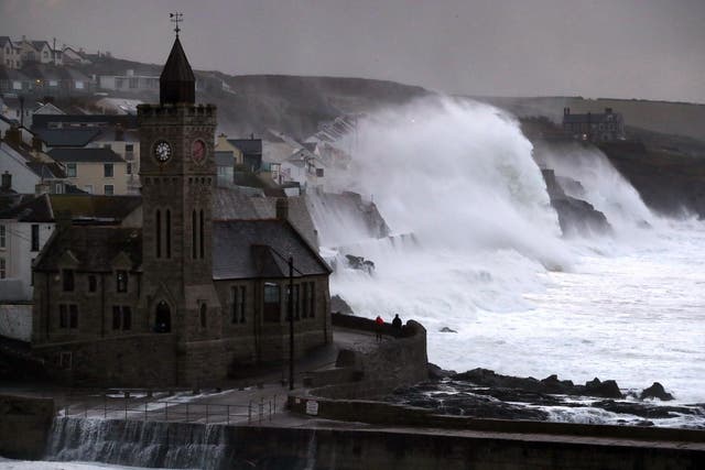 Waves crash into the seafront in Porthleven, Cornwall during 70mph winds in October