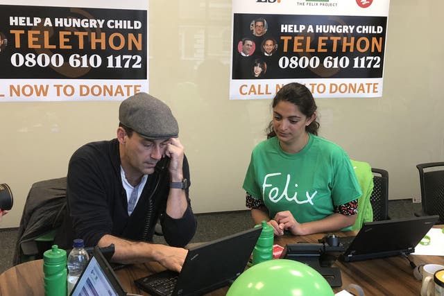 Jon Hamm answering calls in today's Christmas appeal telethon