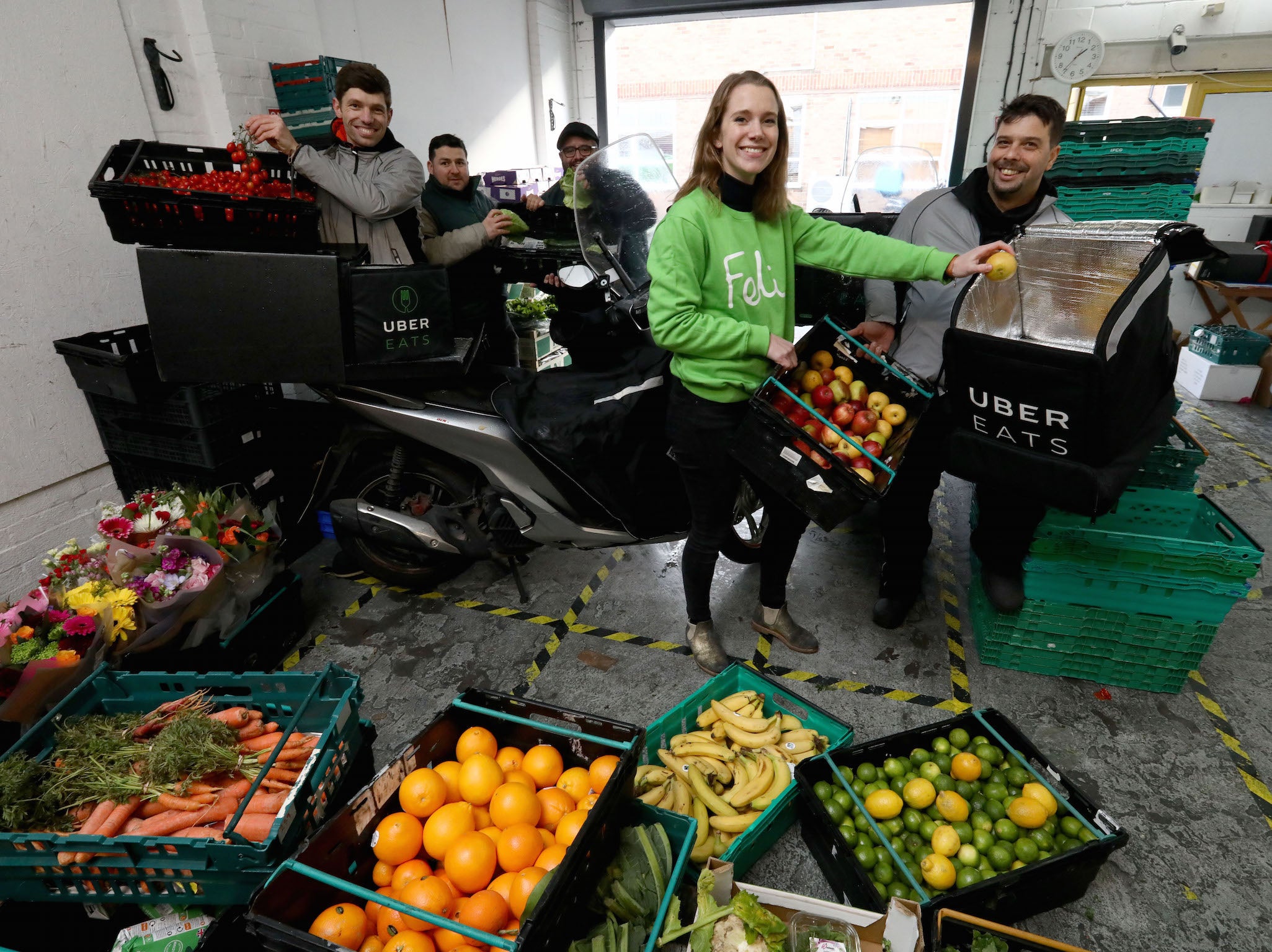 UberEATS drivers pick up food from the Felix depot to be taken to Berrymede Junior School in Acton