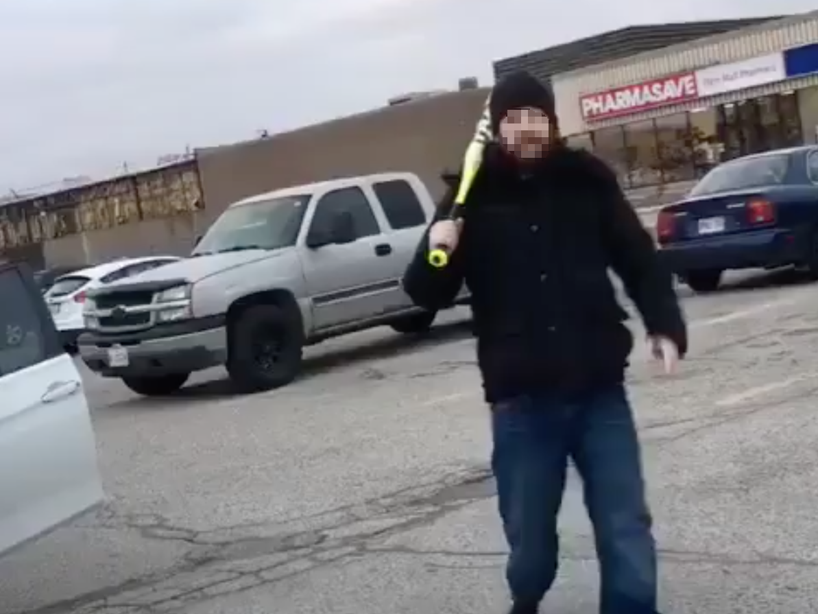 Video posted to Instagram shows a man following a family through a mall parking lot with a baseball bat