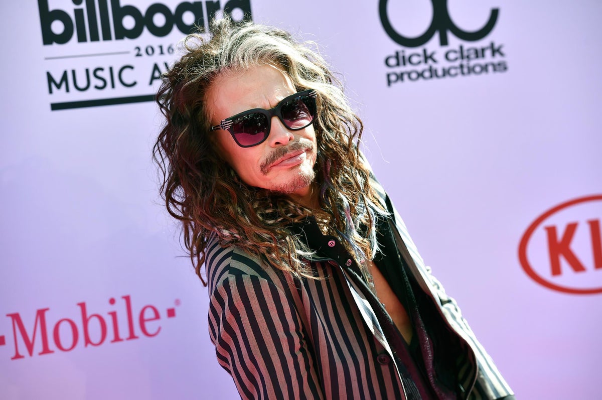 Singer Steven Tyler and his son Taj Tyler arrive for the premiere of