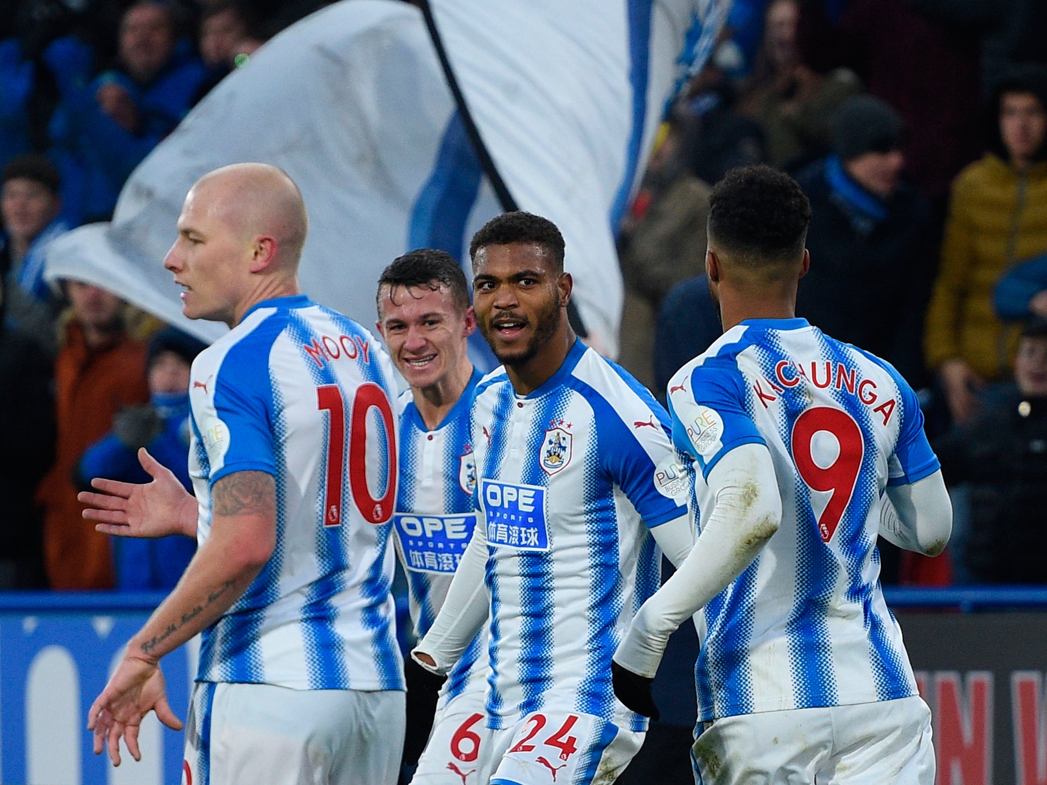 Mounie celebrates with his Huddersfield teammates after doubling the lead