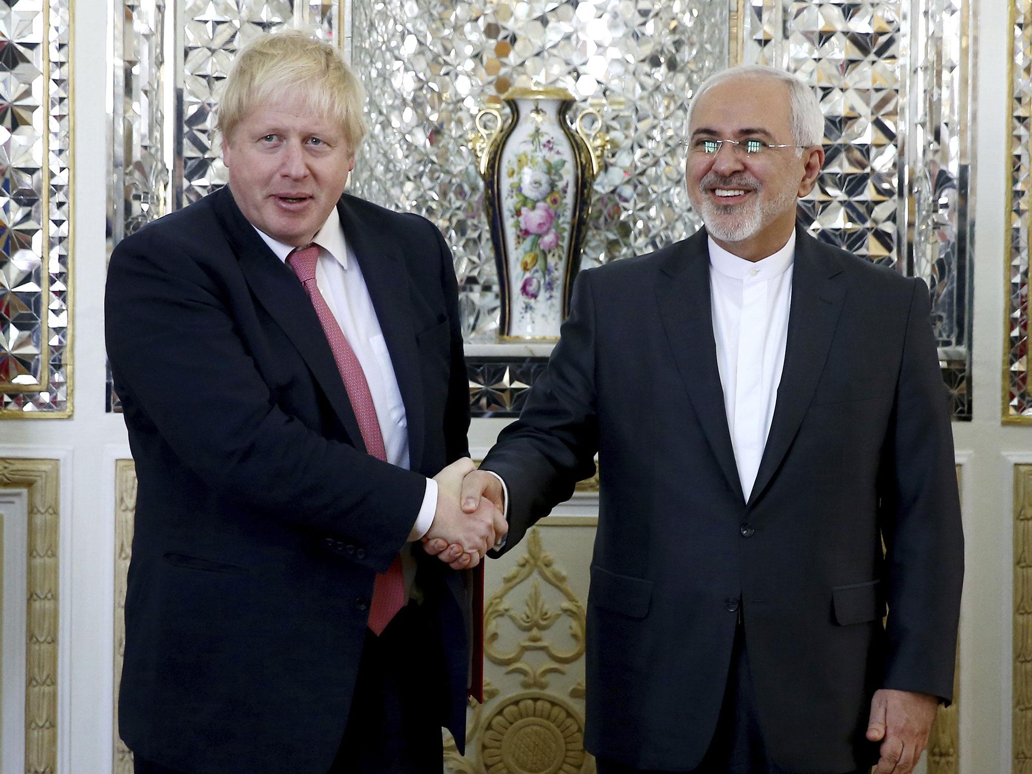 Iranian Foreign Minister Mohammad Javad Zarif, right, and his British counterpart Boris Johnson, shake hands in Tehran on Saturday
