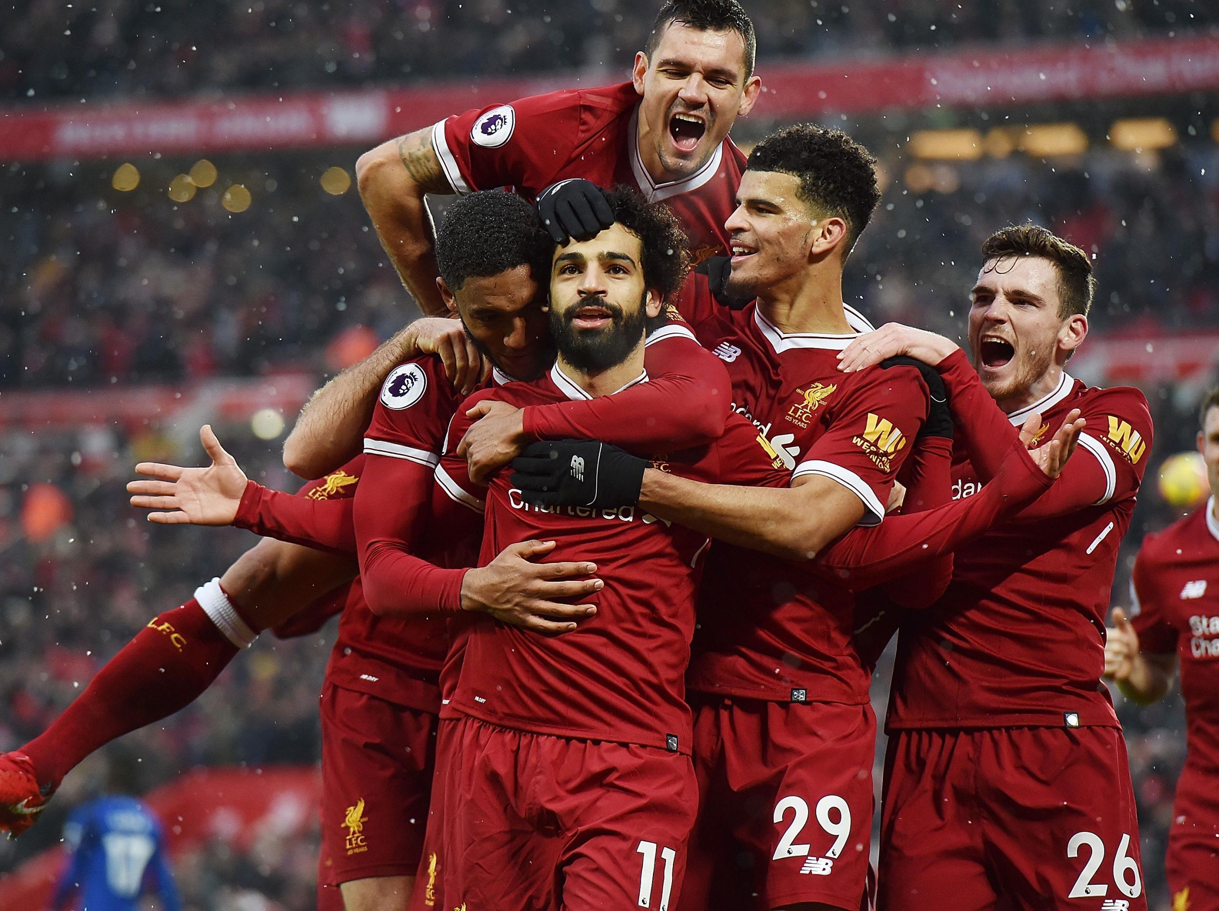 The Liverpool players mob their goalscorer, Mohamed Salah
