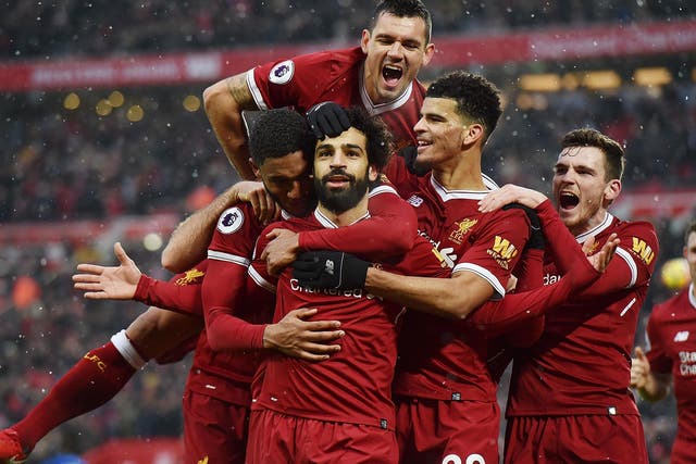 The Liverpool players mob their goalscorer, Mohamed Salah