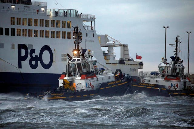 Tugboats manoeuvre the P&O ferry Pride of Kent after it ran aground during bad weather