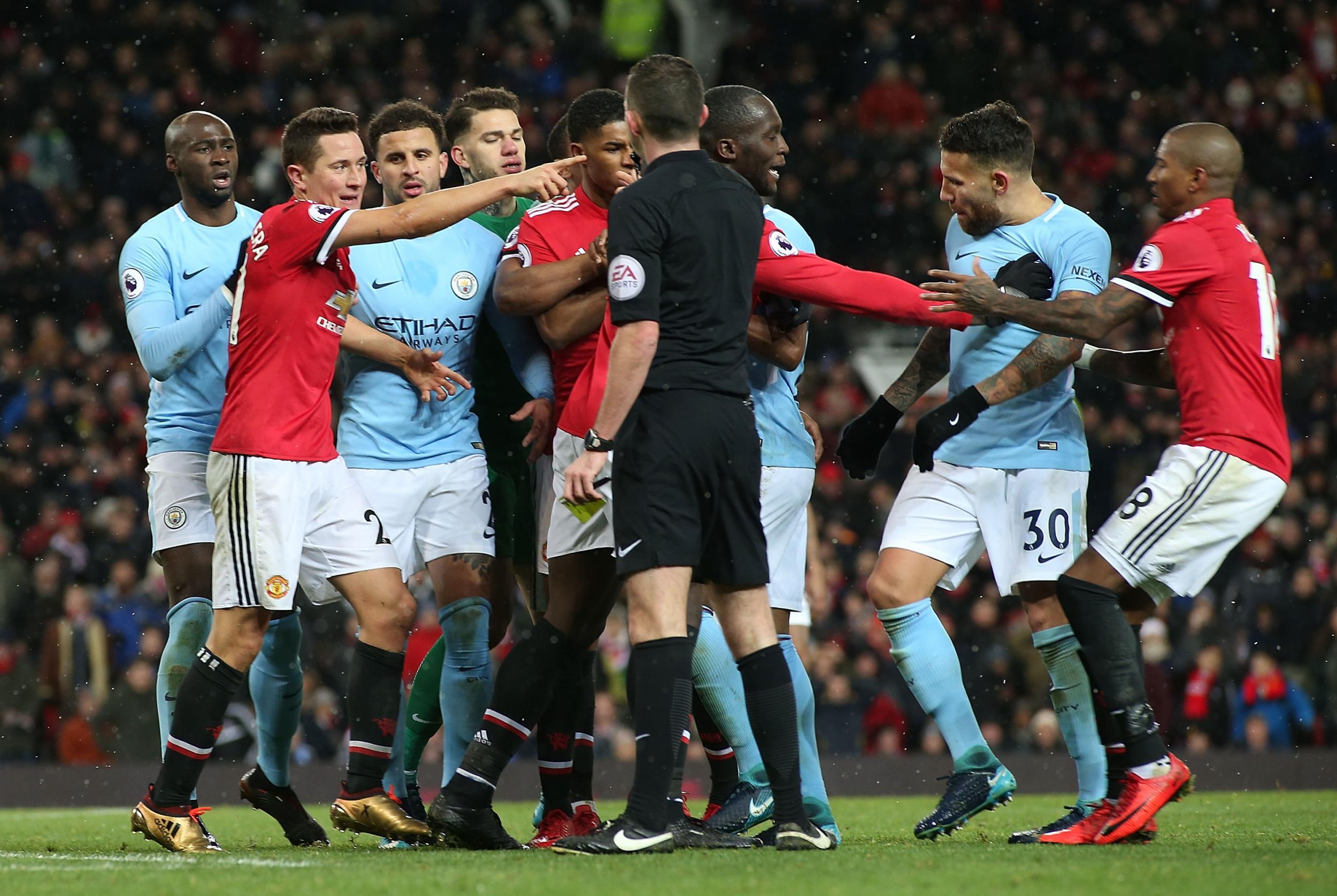 Michael Oliver tries to calm a heated exchange