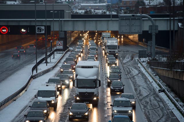 Snow caused long tailbacks on the M25, while hundreds of flights across the UK have been cancelled