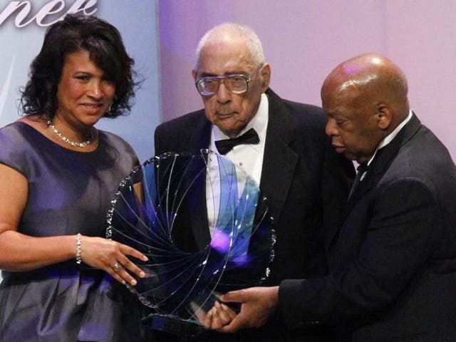 Journalist Simeon Booker, centre, is presented with a Phoenix Award by the Congressional Black Caucus Foundation in Washington on September 2010