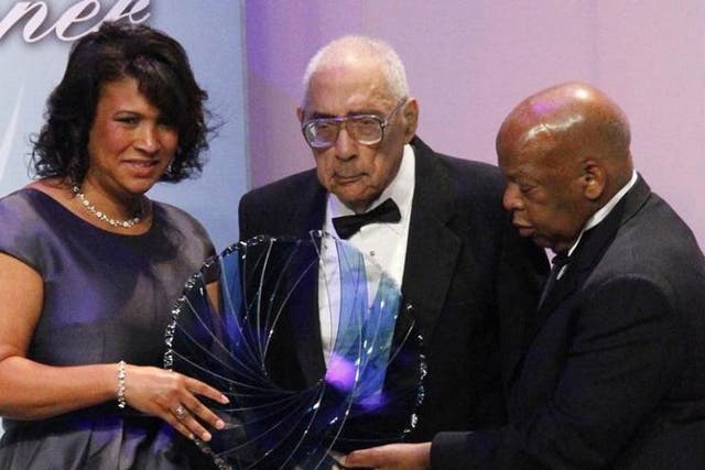 Journalist Simeon Booker, centre, is presented with a Phoenix Award by the Congressional Black Caucus Foundation in Washington on September 2010