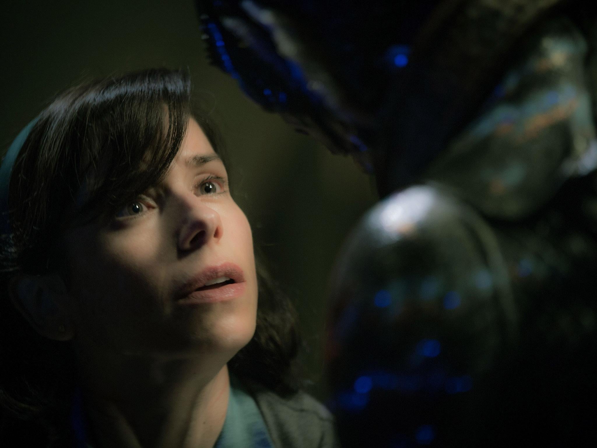 A mute cleaning woman named Elisa (Sally Hawkins) falls in love with an amphibious sea creature (Doug Jones) in ‘The Shape of Water’ (Rex)