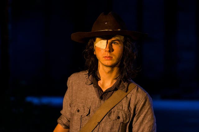 Carl gets bitten in a fight with zombies in the Walking Dead
