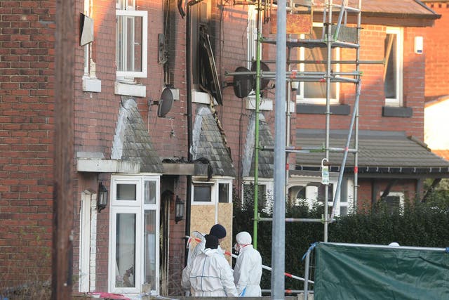 Forensic officers at the scene of a house fire on Jackson Street in Worsley, Greater Manchester, as a murder inquiry has been launched after three children died following the fire
