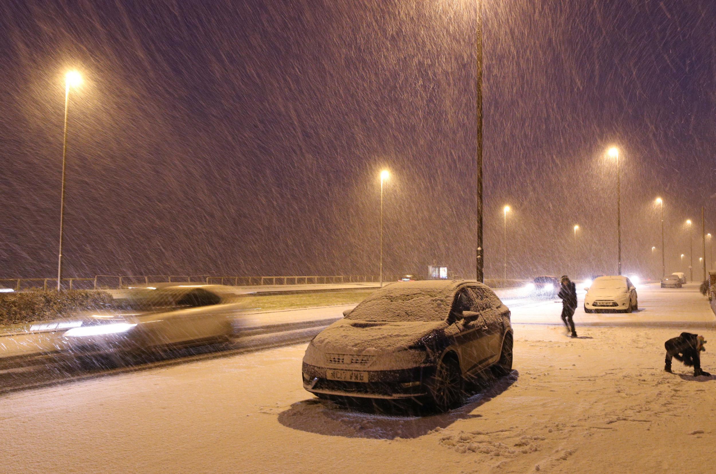 Falling snow in Whiltey Bay, as heavy snowfall across parts of the UK is causing widespread disruption, closing roads and grounding flights at an airport