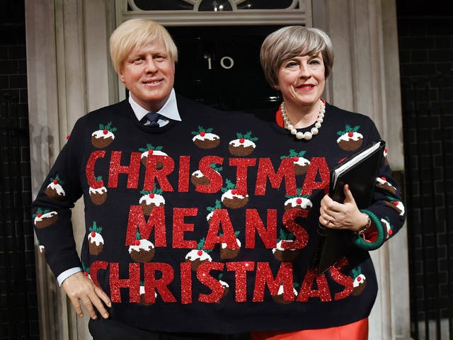 Wax figures of Prime Minister Theresa May and Foreign Secretary Boris Johnson wearing a Christmas Jumper at Madame Tussauds