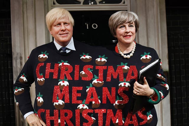 Wax figures of Prime Minister Theresa May and Foreign Secretary Boris Johnson wearing a Christmas Jumper at Madame Tussauds