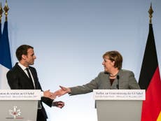 Merkel flies home early from Paris summit for secret coalition talks