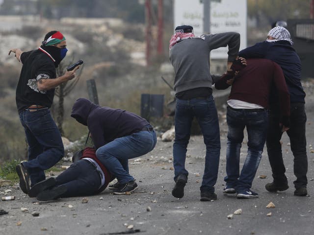 Undercover Israeli police arrest Palestinian demonstrators during clashes following protests against US President Donald Trump's decision to recognise Jerusalem as the capital of Israel, in the West Bank city of Ramallah