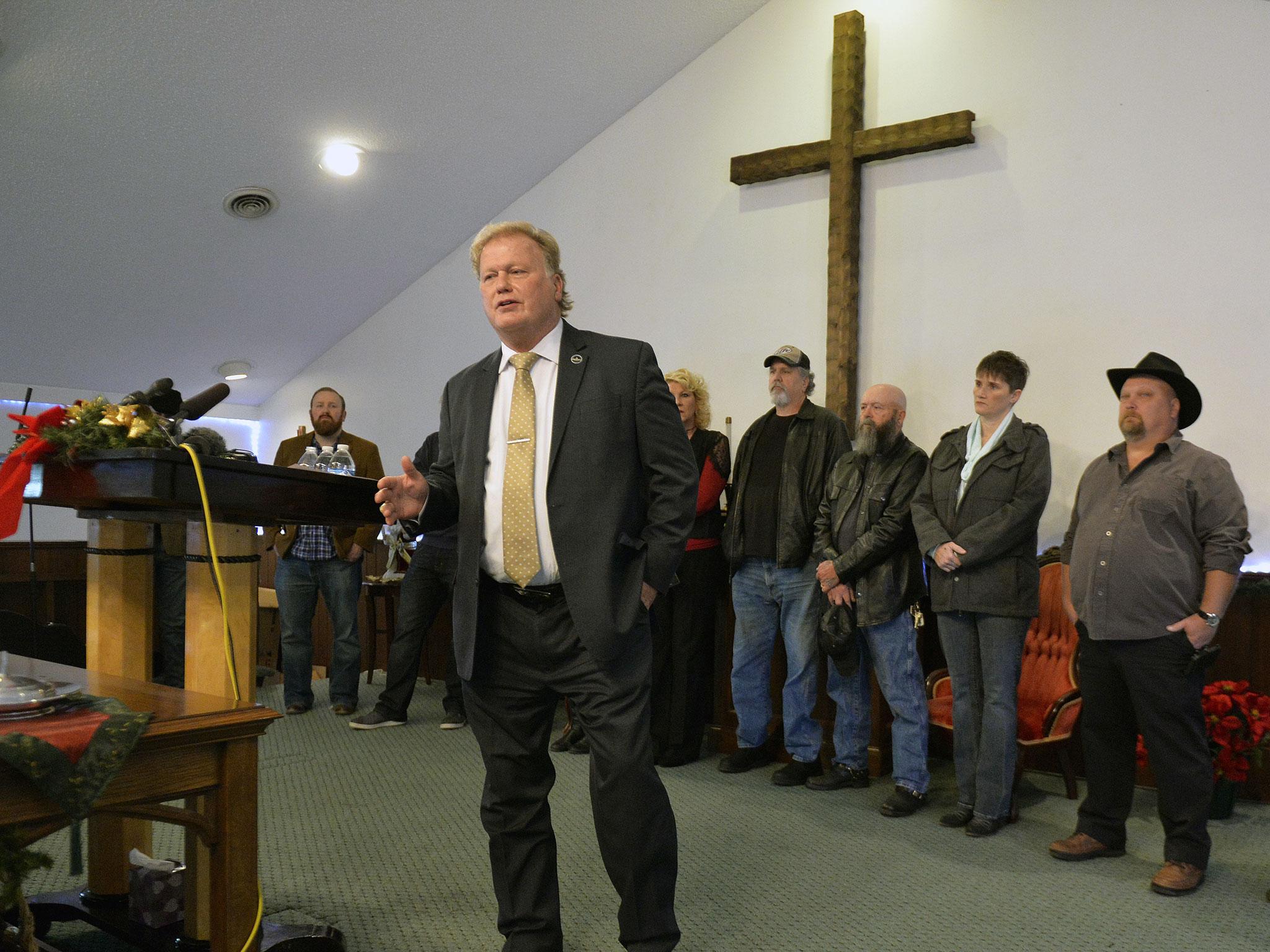 With friends and family standing behind him, Dan Johnson addresses the public from his church regarding allegations he sexually abused a teenager after a New Year's party in 2013