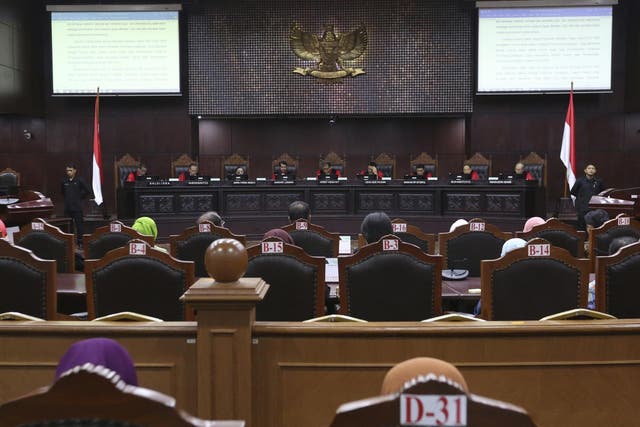 Judges read their verdict on the case of a petition seeking to make gay sex and sex outside marriage illegal during a hearing at the Constitutional Court in Jakarta
