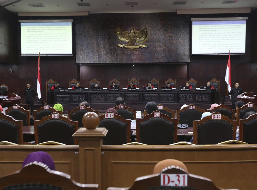 Judges read their verdict on the case of a petition seeking to make gay sex and sex outside marriage illegal during a hearing at the Constitutional Court in Jakarta