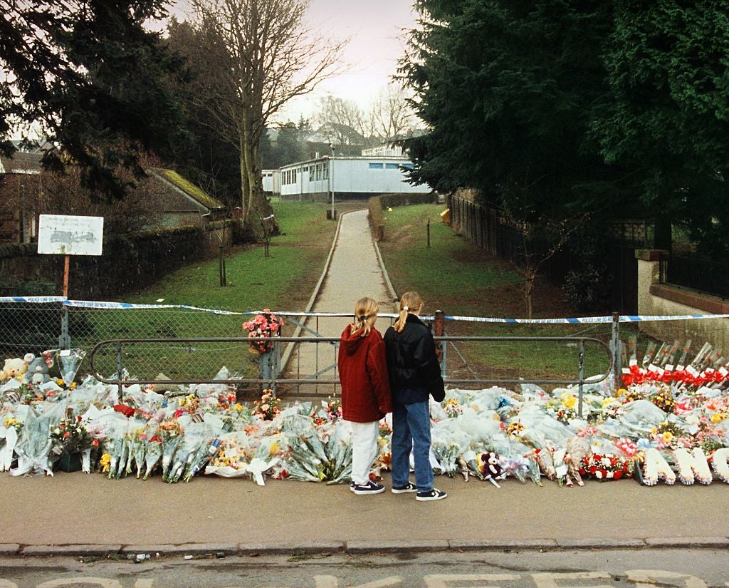 Flowers are laid at the gates of Dunblane Primary School where 16 children and their teacher were shot dead by gunman Thomas Hamilton who then killed himself on 13 March 1996