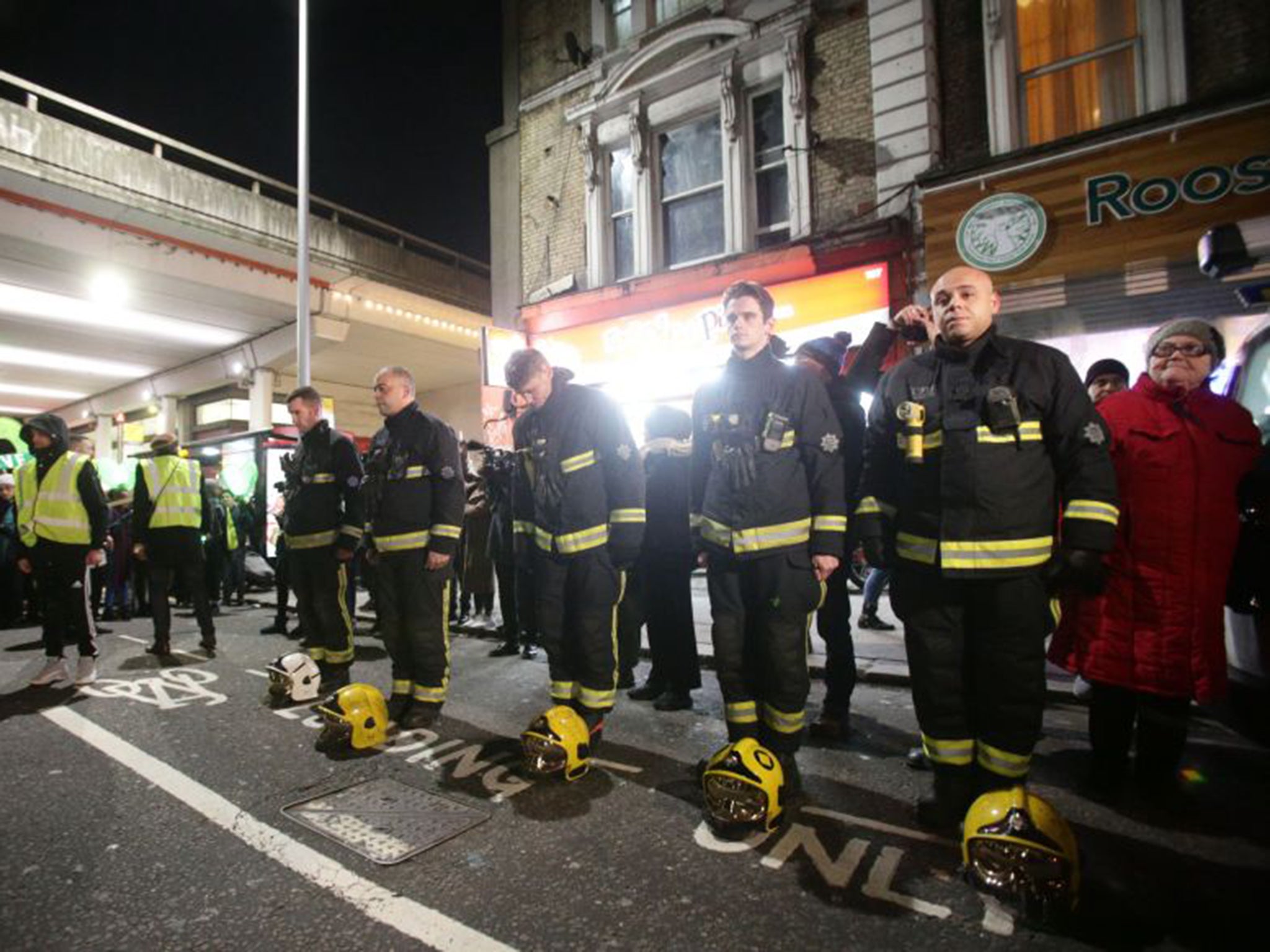 Firefighters pay their respects in a vigil for the Grenfell Tower victims