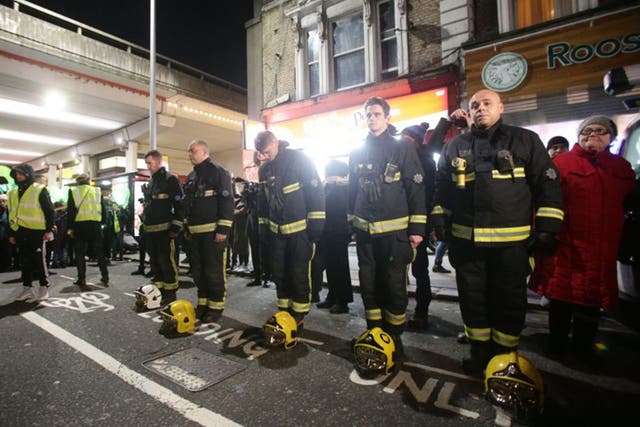 Firefighters pay their respects in a vigil for the Grenfell Tower victims