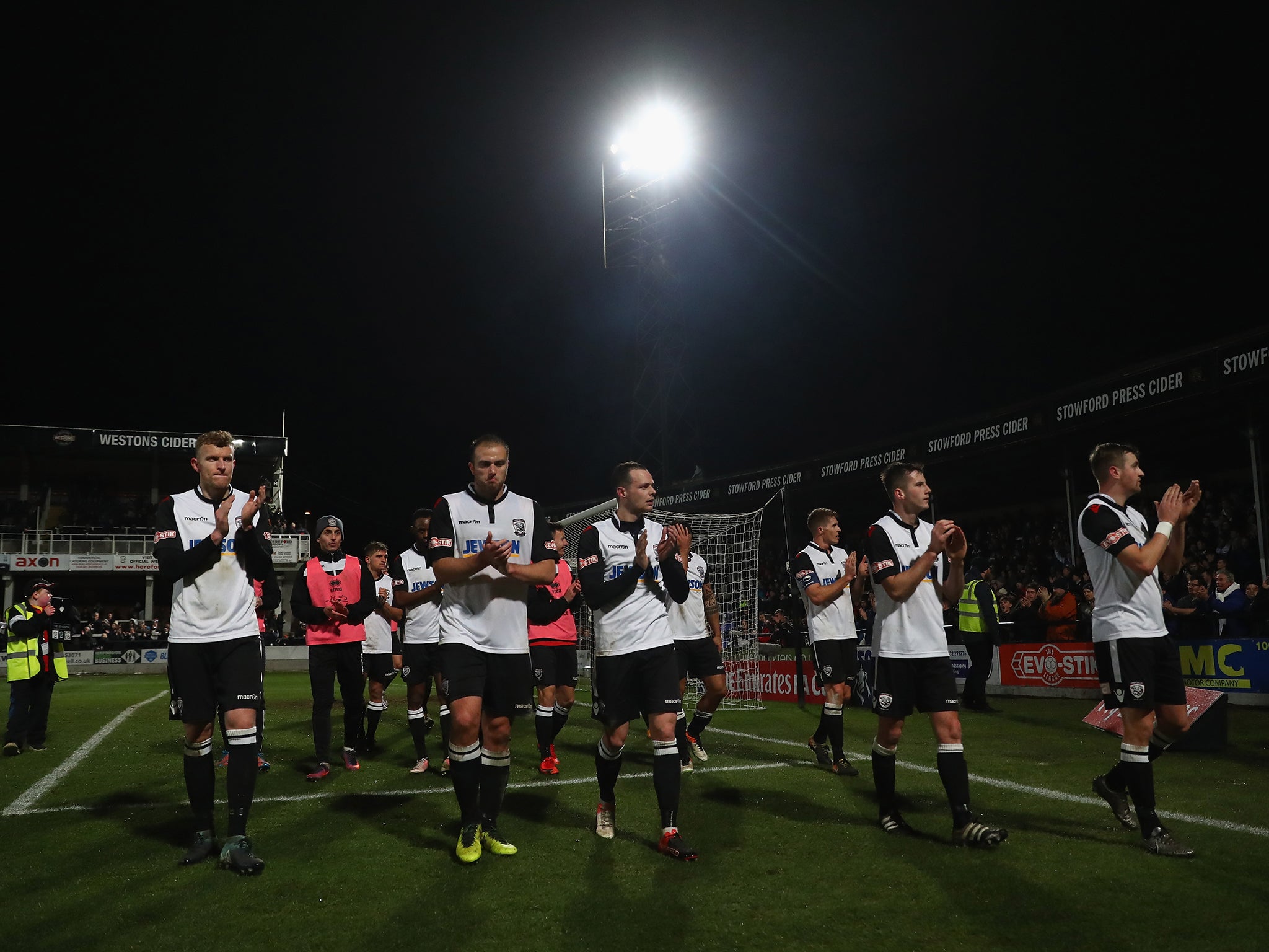 Hereford players applaud their fans after their 2-0 defeat by Fleetwood