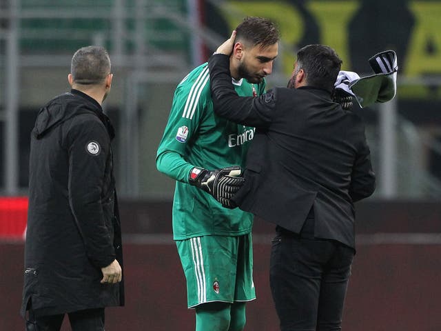 Gianluigi Donnarumma is comforted by AC Milan coach Gennaro Gattuso after the win