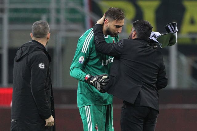 Gianluigi Donnarumma is comforted by AC Milan coach Gennaro Gattuso after the win